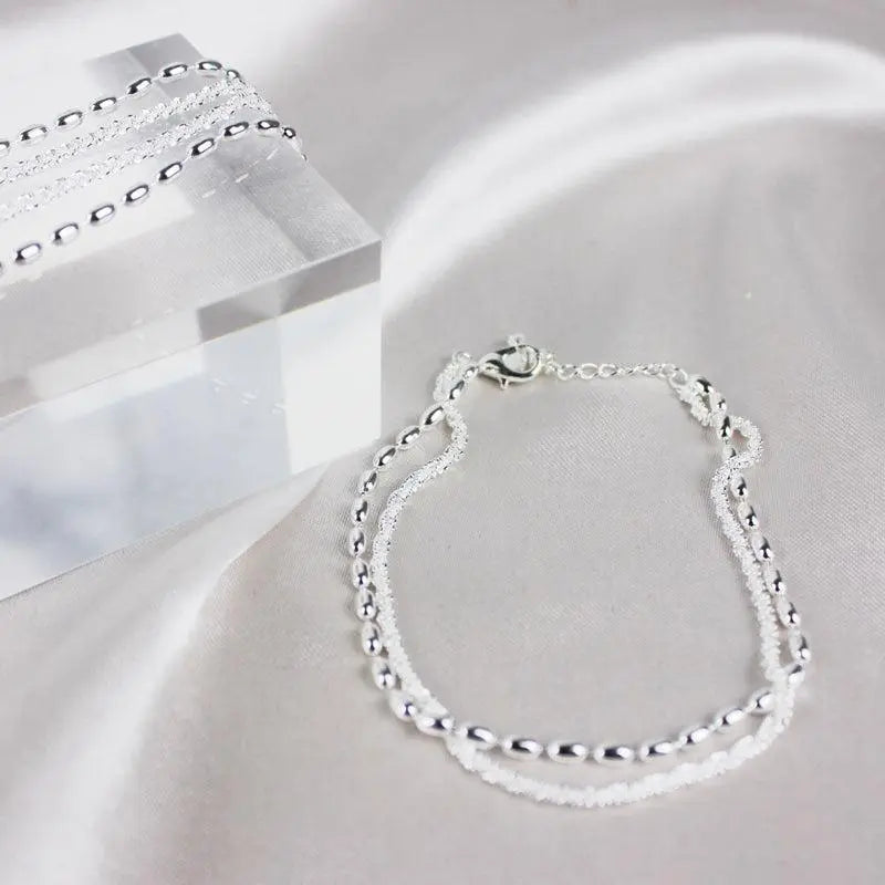 Elegant set of silver bracelets with zirconia stones